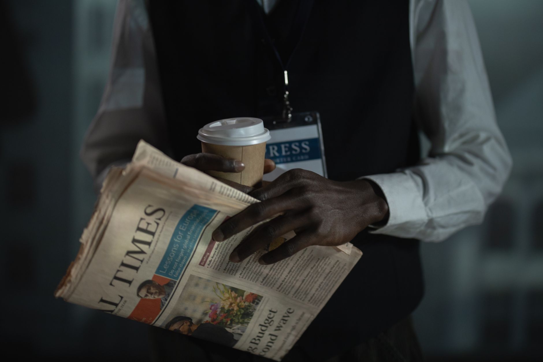 Close-up of a journalist holding a newspaper and coffee cup, conveying press and media concept. — Best crypto mobile casino s