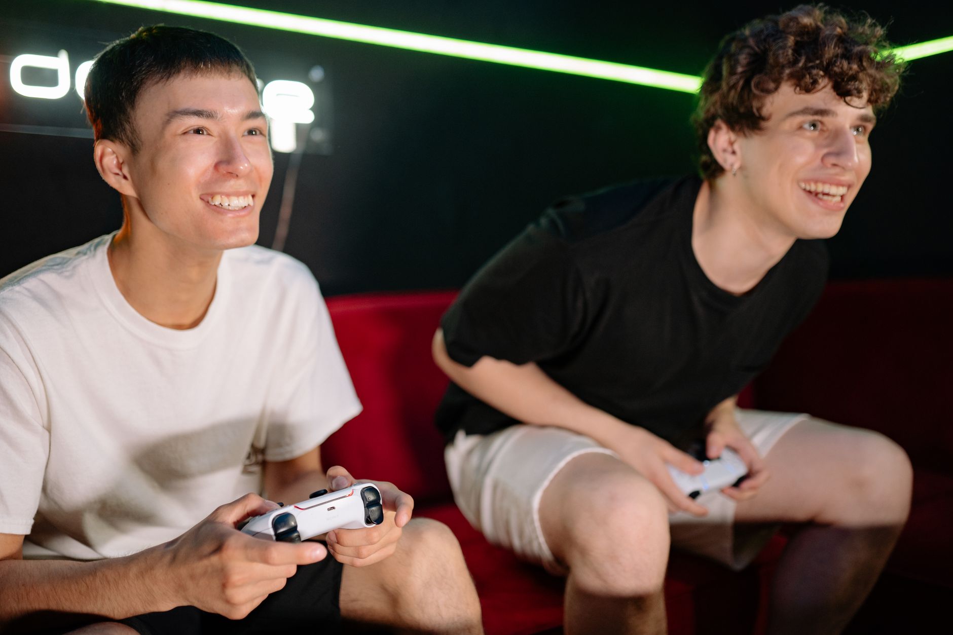 Two friends having fun playing video games indoors, captured in a lively and engaging moment. — How to Avoid Fraud in a New S